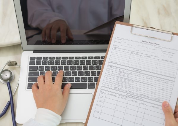 Doctor hands typing on laptop keyboard Doctor hands typing on laptop keyboard
